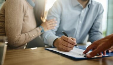 Couple signing a contract in the office