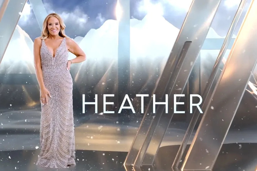 Heather Gay wearing a silver dress in front of a mountain and cloud graphic