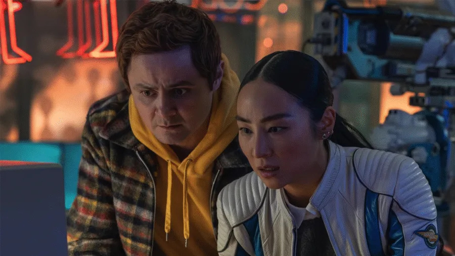 Arturo Castro as Seth Flores and Greta Lee as ENCOM CEO Eve