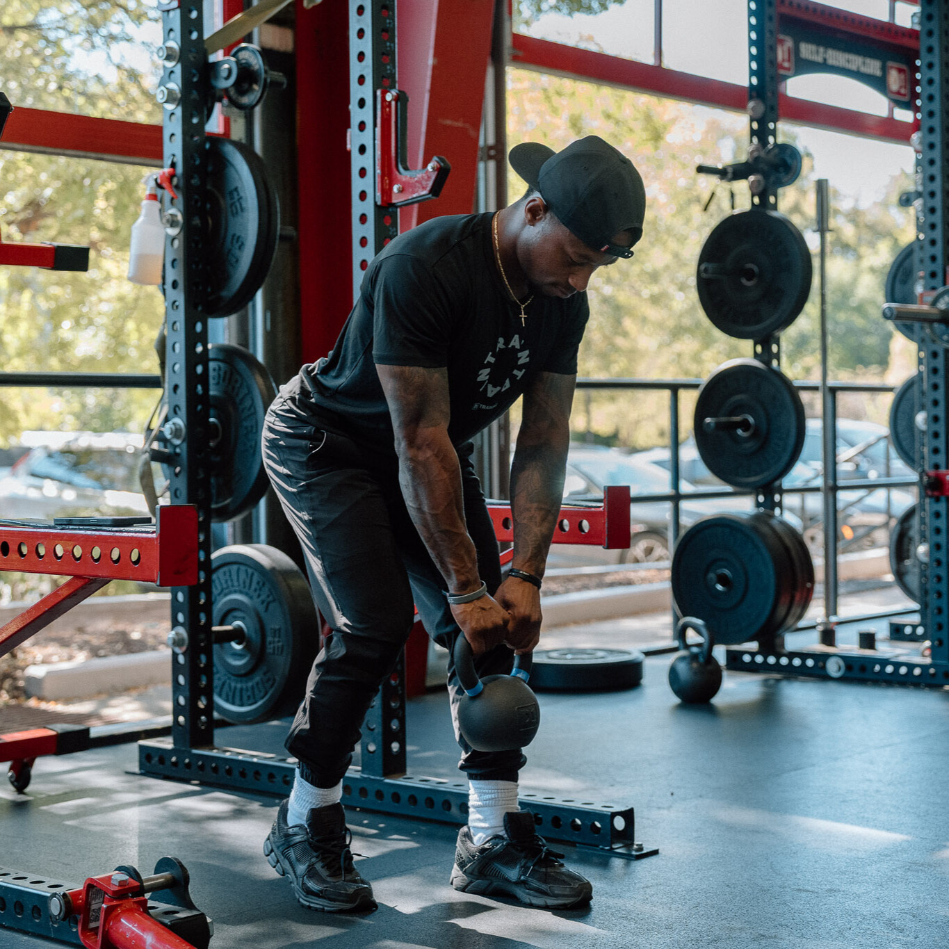 Man demonstrates kettlebell exercise in gym