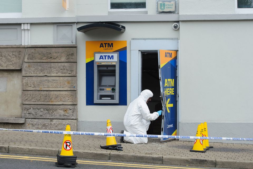 Garda crime scene investigators carrying out a technical examination at the ATM in Clones Town on August 1. Photo Rory Geary