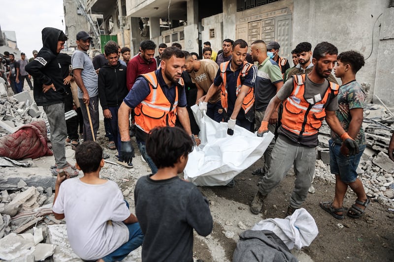 Palestinians carry a body they recovered from the rubble of a house destroyed in an overnight Israeli strike in Gaza City on Wednesday. Photograph: Omar Al-Qatta/AFP via Getty Images