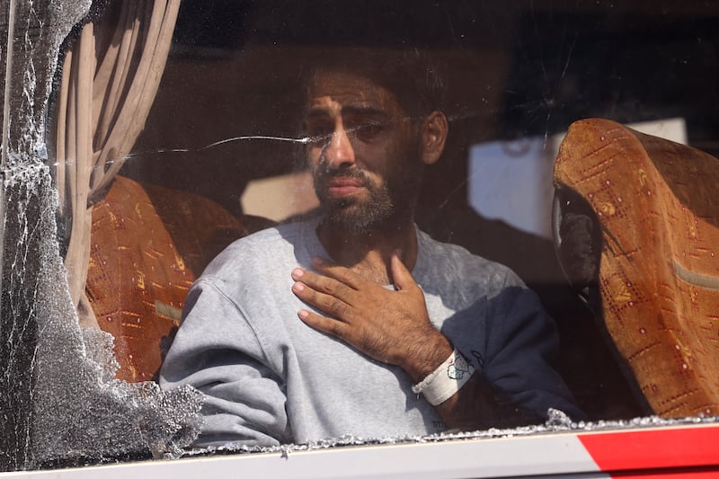A Palestinian released from an Israeli prison  arrives on a bus outside the Nasser Hospital in Khan Yunis in the southern Gaza Strip. Photograph: AFP via Getty Images       