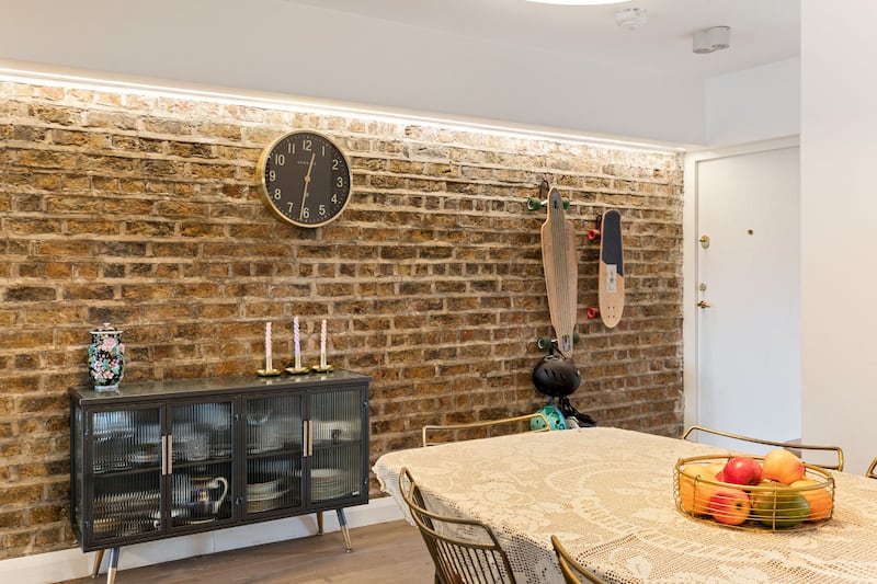The dividing wall with the period house next door is now exposed and illuminated