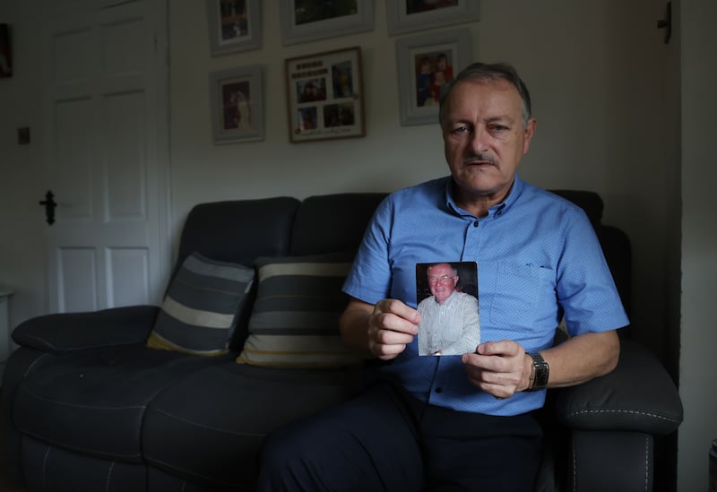 Michael Walsh holds a photo of his cousin Tom Niland. Walsh is still haunted by witnessing his cousin’s painful deterioration over those 20 months. Photograph: Bryan O’Brien