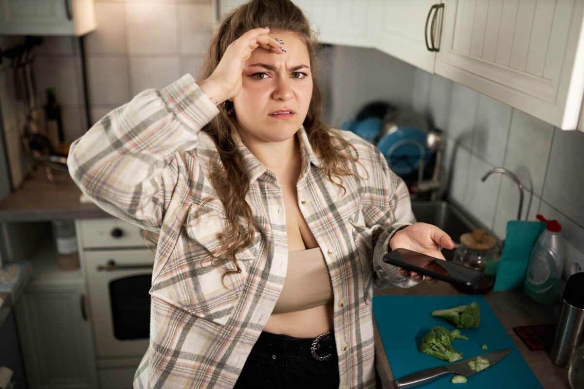 Woman frustrated with smartphone fitness app for diet