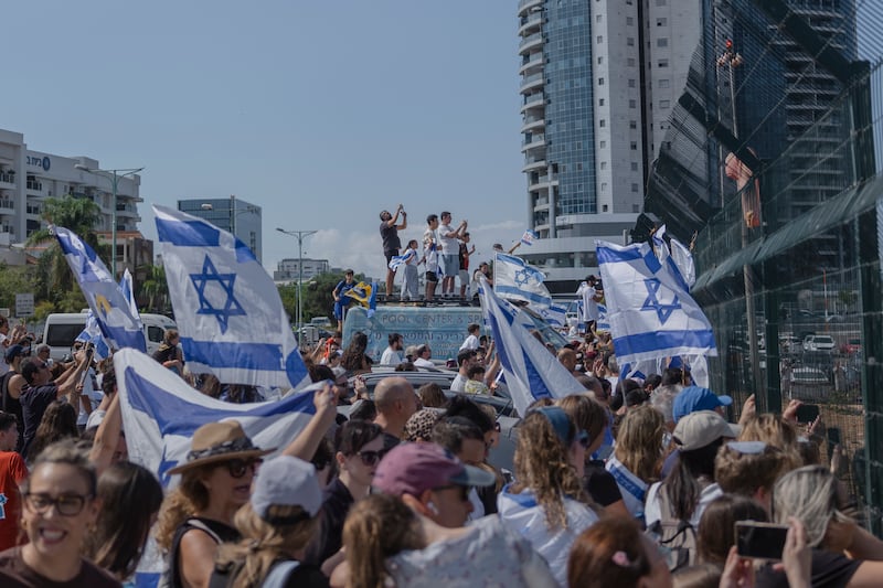 Crowds gather as a helicopter carrying hostages freed from captivity by Hamas in Gaza arrives at Beilinson Hospital in Petah Tikva, Israel. Photograph: Amit Elkayam/New York Times
                      