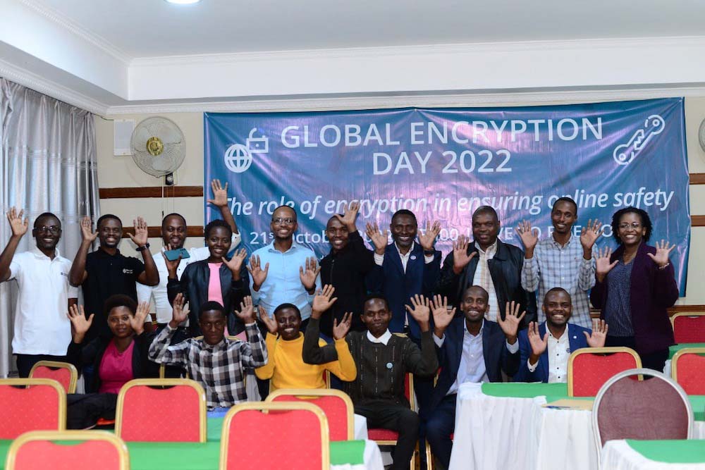 The Internet Society Rwanda Chapter stands in front of a sign for Global Encryption Day 2022