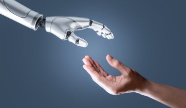 image of a humanoid hand reaching out to a human hand
