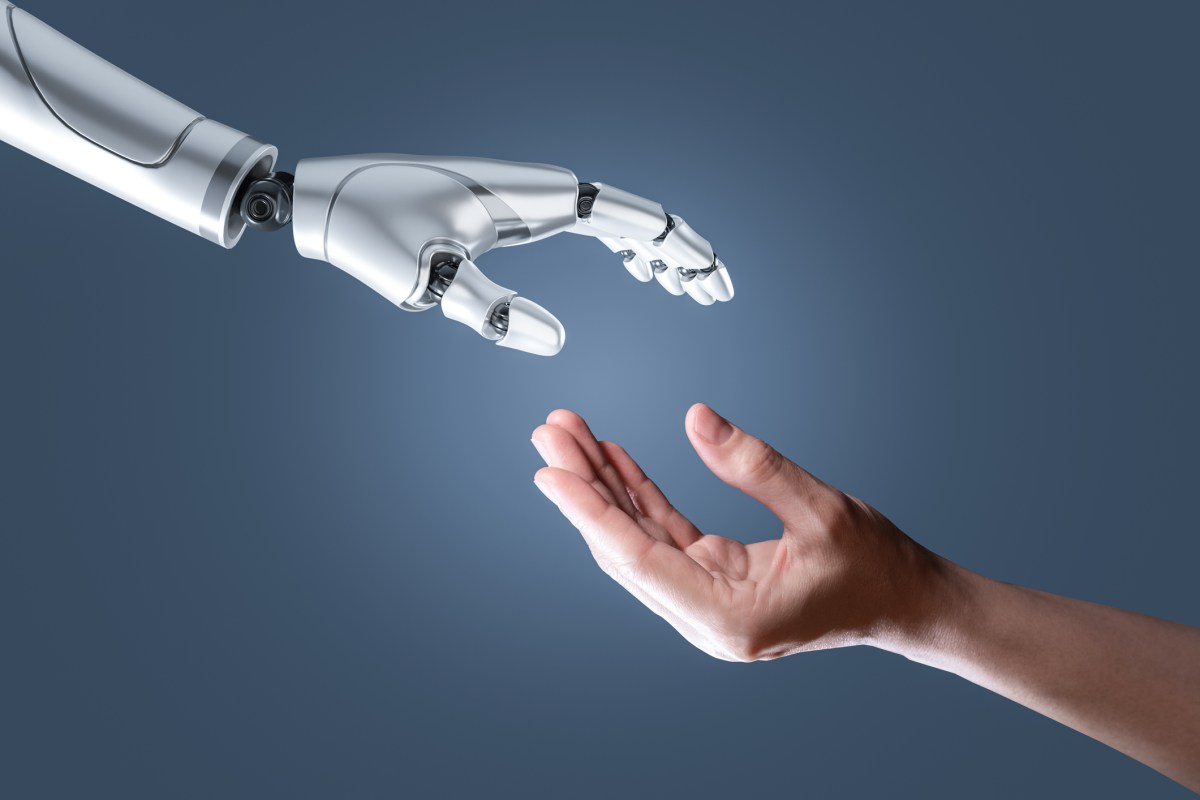 image of a humanoid hand reaching out to a human hand