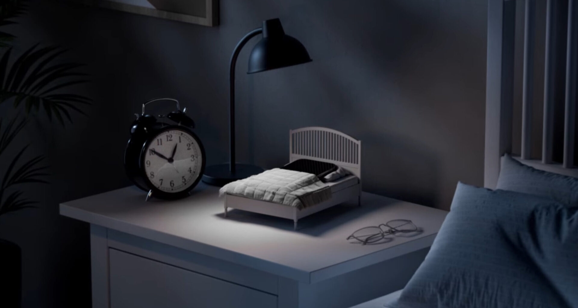 A smartphone tucked into the IKEA Phone Sleep Collection bed.