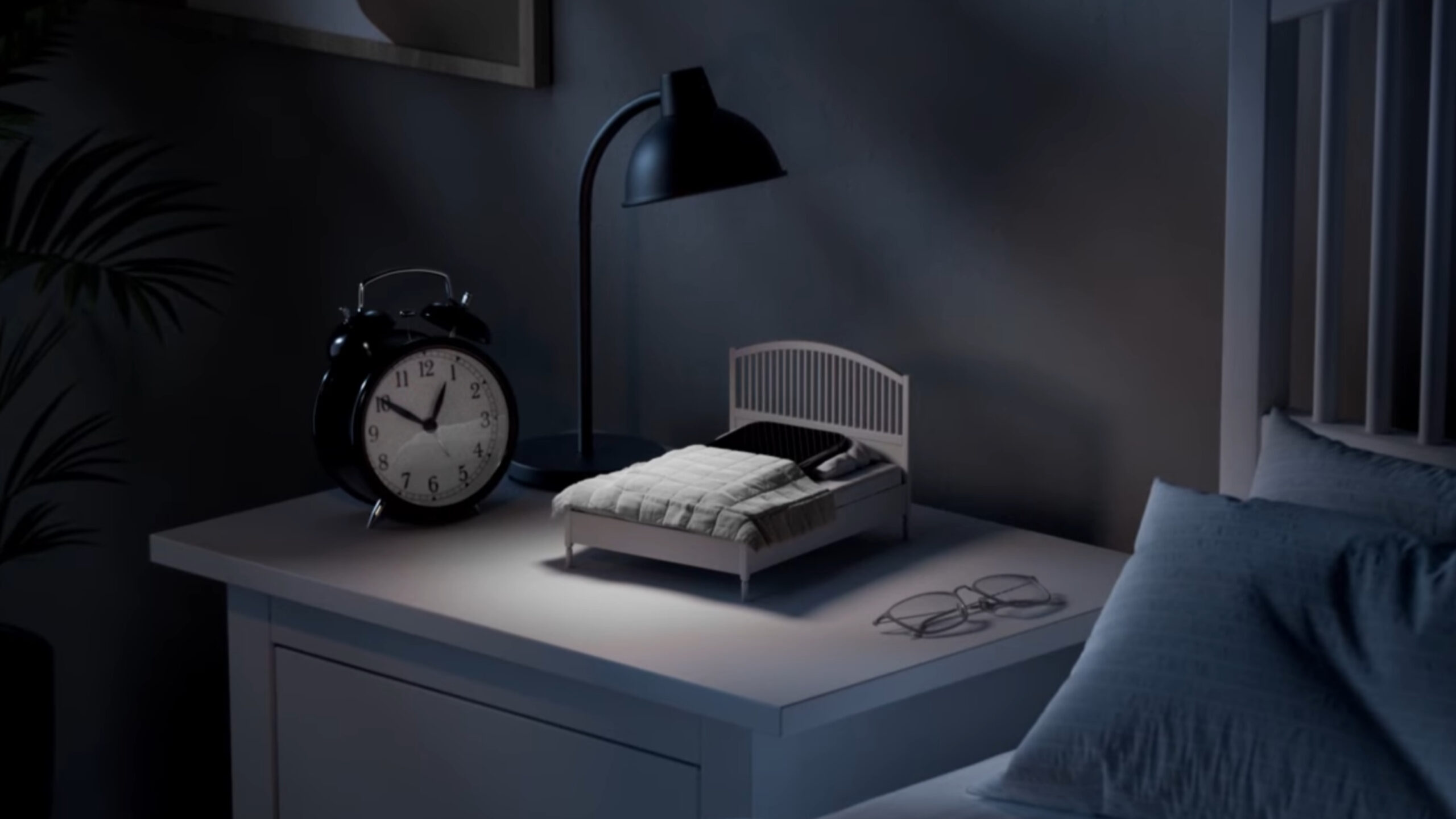 A smartphone tucked into the IKEA Phone Sleep Collection bed.