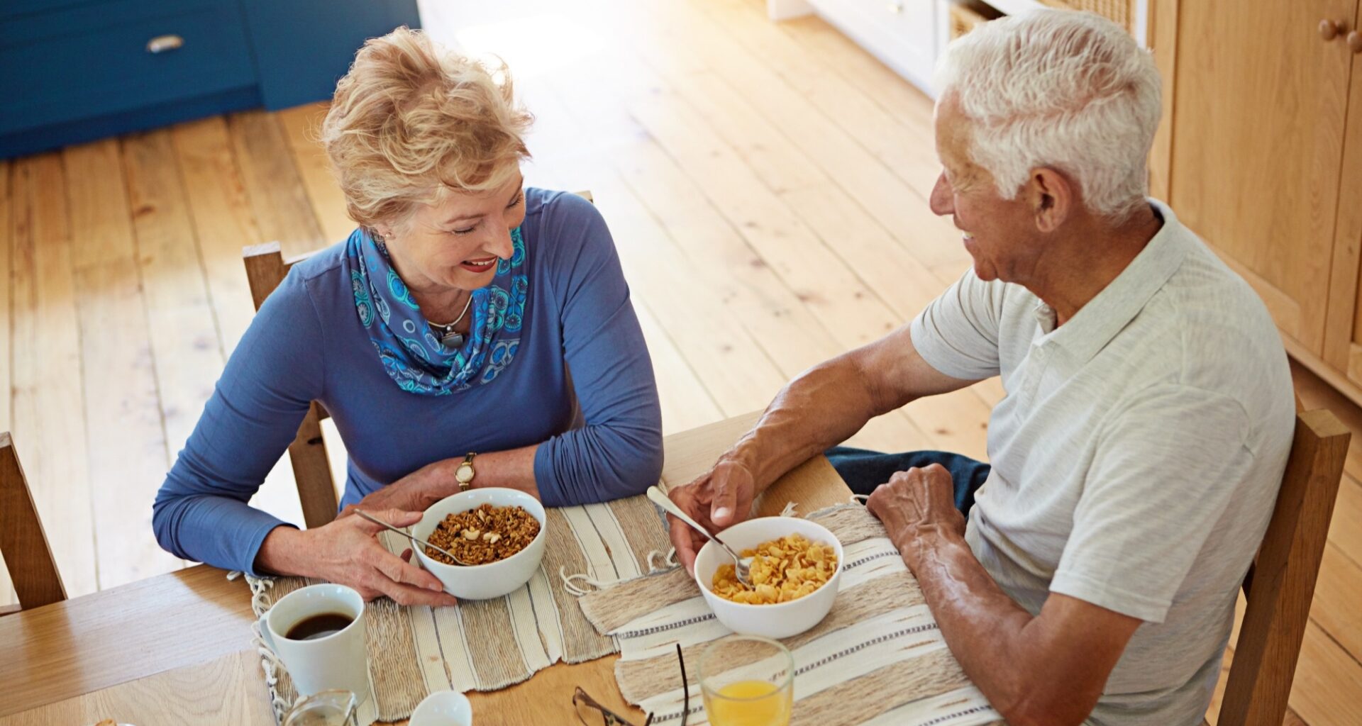 Elderly couple eating at breakfast in dining room