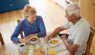 Elderly couple eating at breakfast in dining room