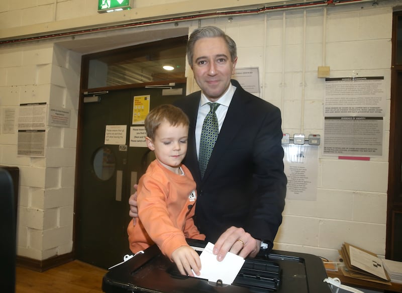 Tánaiste Simon Harris with his son Cillian as the Fine Gael leader cast his vote in the presidential election at Delgany National School in Co Wicklow this morning. Photograph: Stephen Collins/Collins Photos 