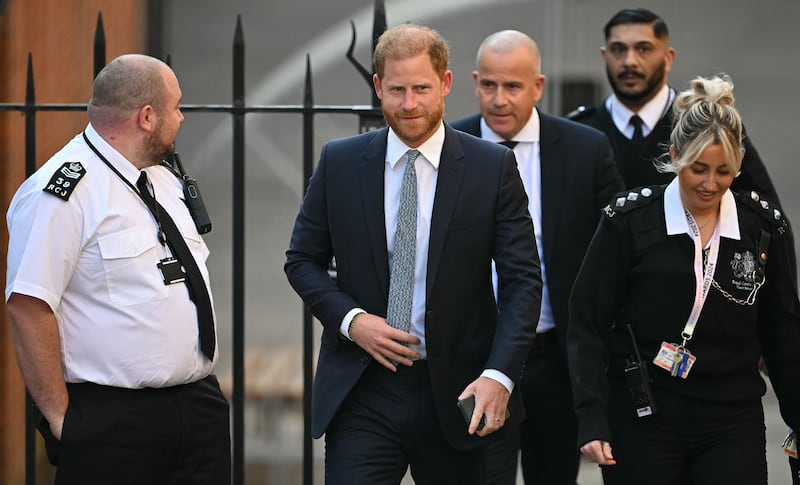 Prince Harry, Duke of Sussex, walks with security as he arrives at the Royal Courts of Justice, Britain's High Court, in central London, on April 8, 2025. Prince Harry will push ahead with a court challenge in London on Tuesday as the self-exiled royal fights a decision to downgrade his personal security when he visits Britain. Following Harry's dramatic split with the royal family in 2020 and subsequent move to North America, the British government said he would no longer be given the "same degree" of publicly funded protection when in the UK. (Photo by JUSTIN TALLIS / AFP) (Photo by JUSTIN TALLIS/AFP via Getty Images)