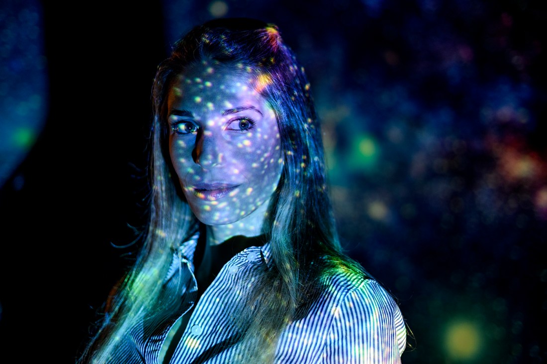 Jacqueline McCleary, an associate professor in the College of Science, shown with a lighting effect of the starry night sky reflecting off her face.