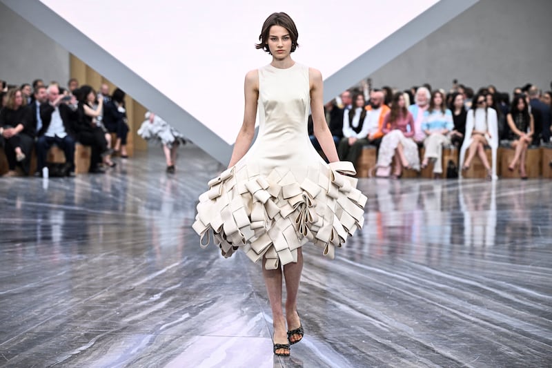That archive was the starting point of the collection: twisted, folded, pleated and looped garments that resulted in silhouettes that veered from shapely hourglass dresses to hooped or bouffant skirts. Photograph: JULIEN DE ROSA/AFP via Getty Images      