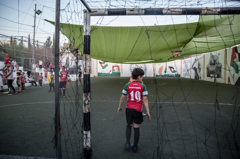 Children play football in the grounds of the Lajee Cultural Centre in Aida refugee camp