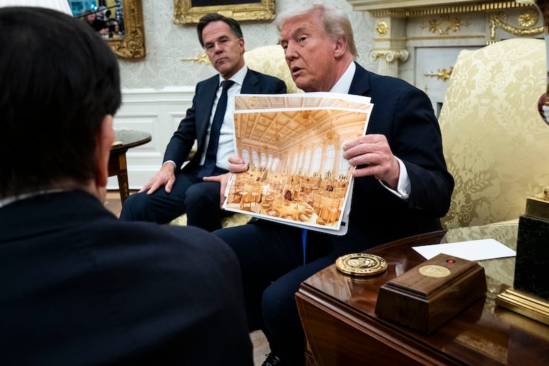 President Donald Trump holds a rendering of the new White House ballroom as he meets Nato secretary general Mark Rutte in the Oval Office. Photograph: New York Times 