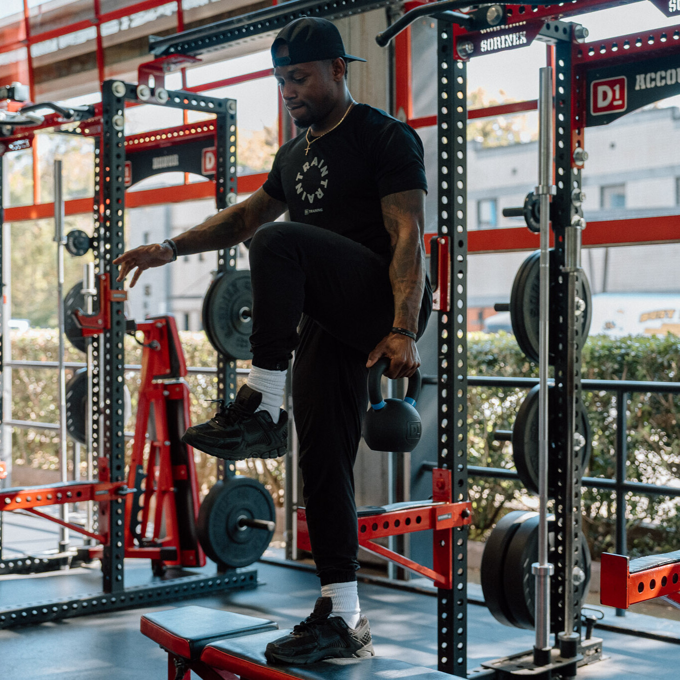 Man demonstrates kettlebell exercise in gym