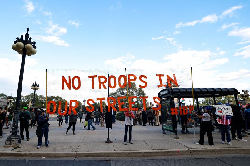 People participate in a demonstration against the planned deployment of National Guard troops in Chicago. Photograph: Kamil Krzaczynski/AFP via Getty          