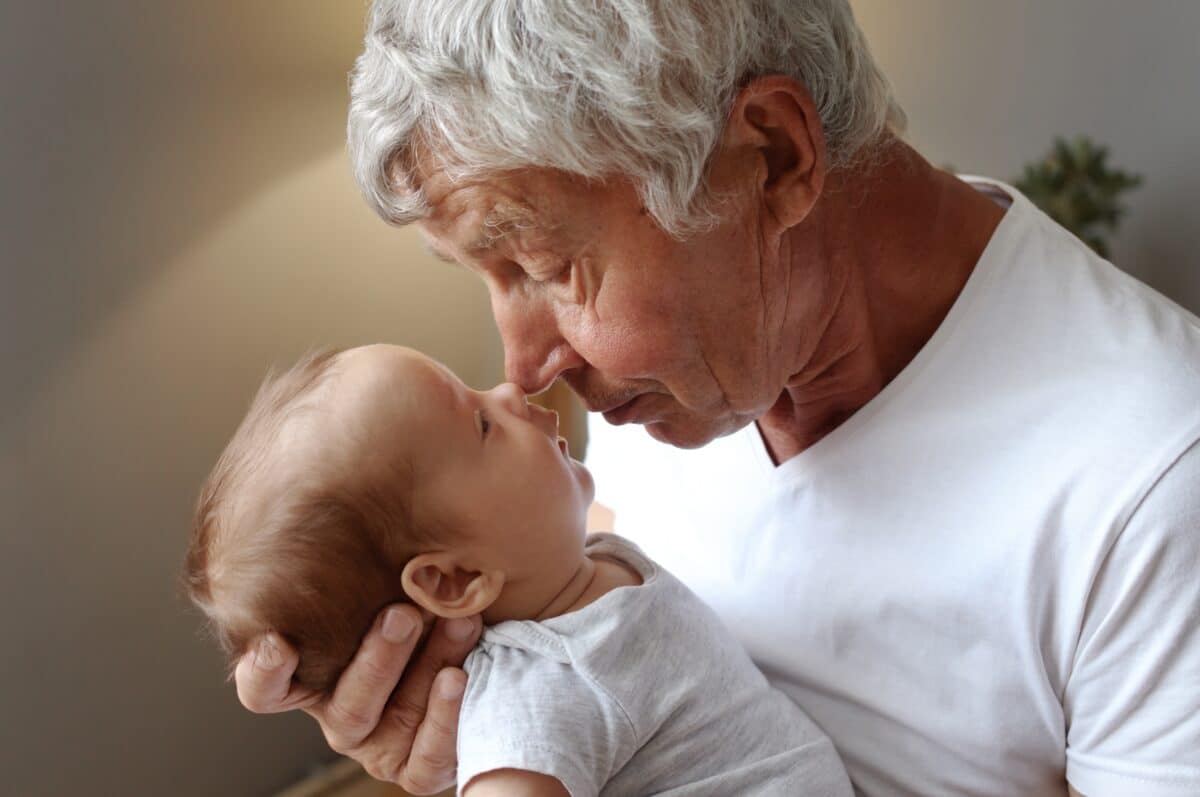 Grandfather or older father holding baby