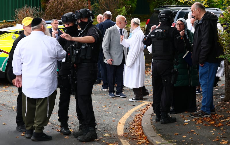 Armed police officers talk with members of the community near Heaton Park Hebrew Congregation synagogue in Crumpsall, north Manchester. Photograph: PAUL CURRIE/AFP via Getty Images         