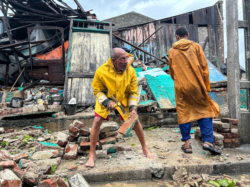 A family salvages belongings from the rubble of their home after it collapsed during Hurricane Melissa's passage through Santiago de Cuba, eastern Cuba, on Wednesday. Photograph: Yamil Lage/AFP via Getty Images         