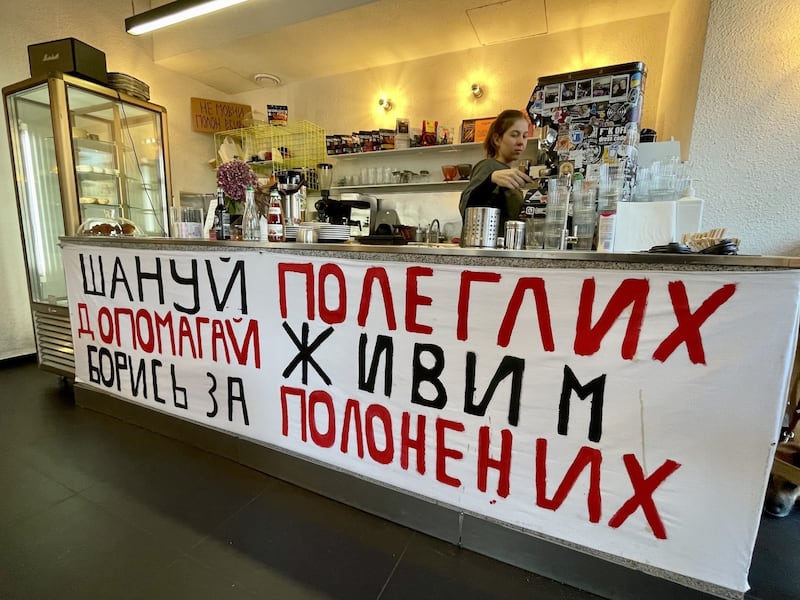 A banner on the counter in a cafe in Lviv in western Ukraine reads: "Respect the fallen. Help the living. Fight for prisoners of war". Photograph: Daniel McLaughlin