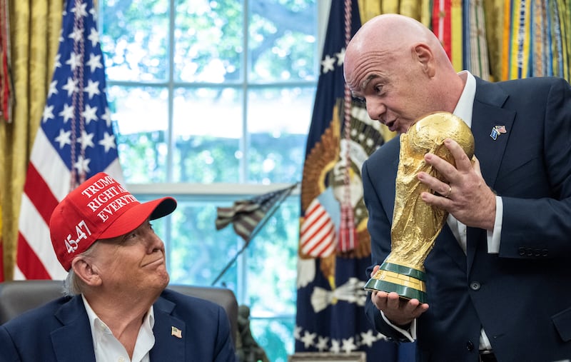 Fifa president Gianni Infantino hands the World Cup trophy to US president Donald Trump in the Oval Office last August. Photograph: Andrew Caballero-Reynolds/Getty Images