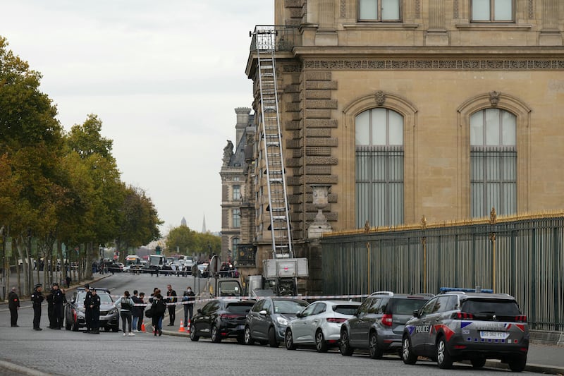 French police officers stand next to a furniture elevator used by robbers to enter the Louvre Museum, on Quai Francois Mitterrand, in Paris. Photograph: DIMITAR DILKOFF/AFP via Getty Images    