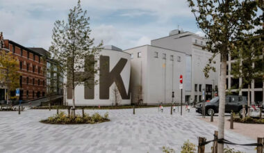 View of a museum building with a plaza in front.
