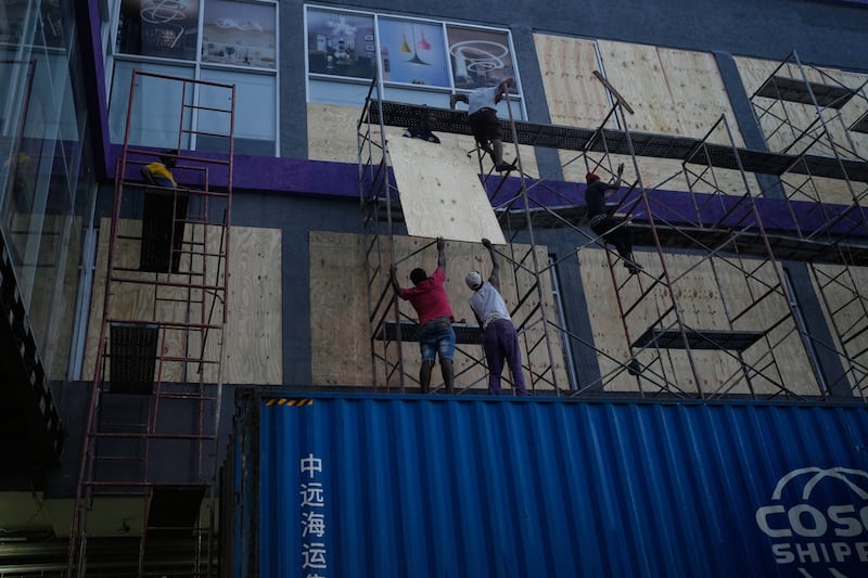 Workers board up shop windows ahead of Hurricane Melissa’s forecast arrival in Kingston, Jamaica. Photograph: Matias Delacroix/AP