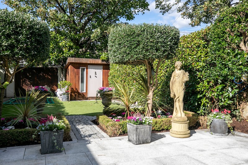 Back garden with patio and studio