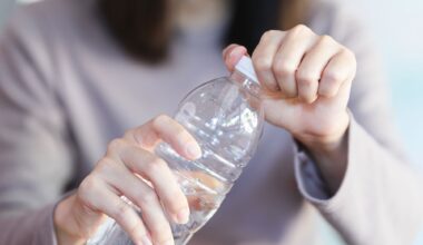 Woman Opening Plastic Water Bottle