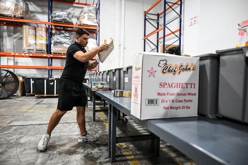 Volunteers assemble relief packages ahead of  Hurricane Melissa at the Global Empowerment Mission headquarters in Miami, Florida. Photograph: Chandan Khanna/AFP via Getty Images