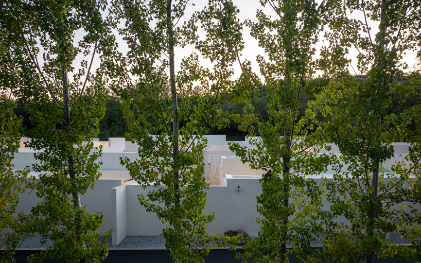 cluster of interwoven white courtyard houses reinterprets ancient kilns for resort in china