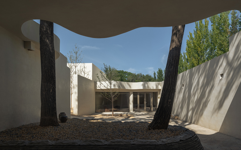 cluster of interwoven white courtyard houses reinterprets ancient kilns for resort in china