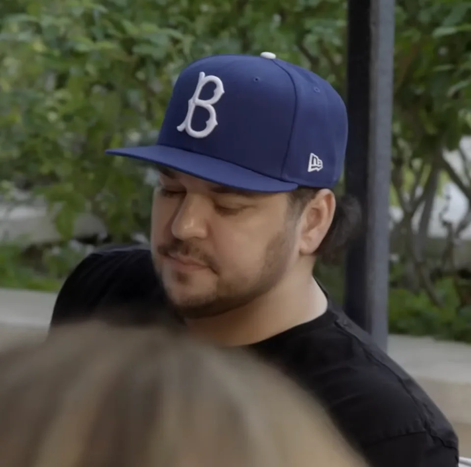 Rob Kardashian is wearing a baseball cap