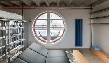 Living space in apartment with large round window