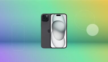 Black iPhone 15 displayed against a gradient purple, pink, teal, and green background