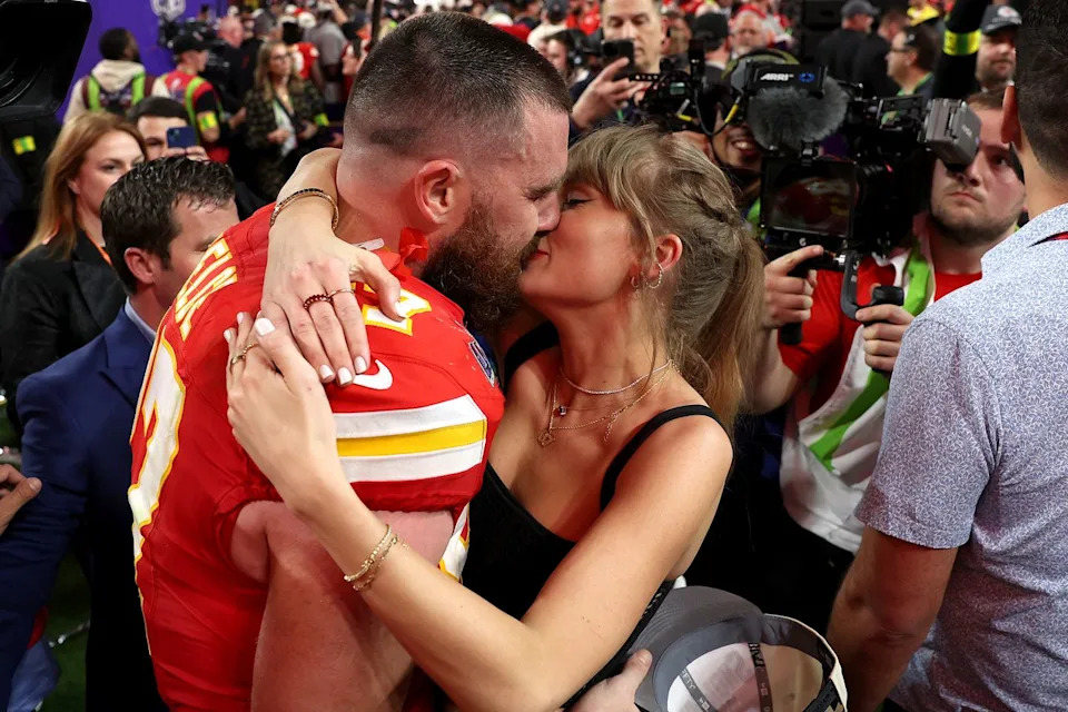 Ezra Shaw/Getty Travis Kelce kisses Taylor Swift at Super Bowl LVIII