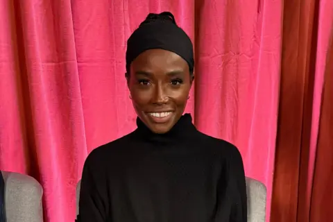 Lorraine wearing a black turtleneck jumper in the Woman's Hour studio