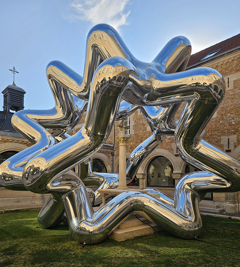 cyril lancelin's inflatable sculpture of star loops reflects the courtyard of étrépagny library