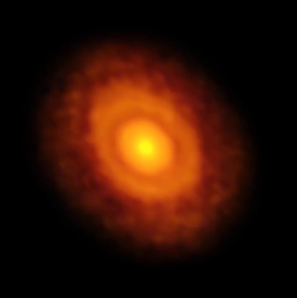 Glowing rings of light show a planet forming disk in the darkness of space