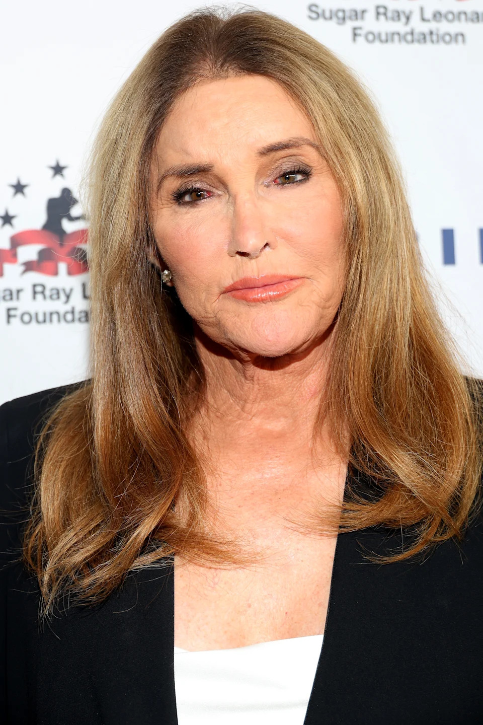 Caitlyn Jenner is wearing a black blazer and white top
