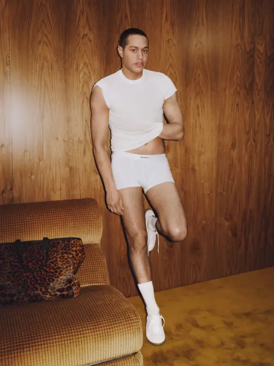 Pete in a fitted t-shirt and boxer briefs, with tattoo-free skin on show