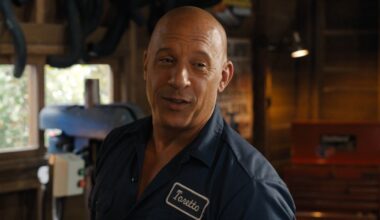 Vin Diesel having a happy conversation in his garage while wearing his work shirt in Fast X.