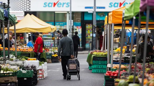 A person walks through a food market
